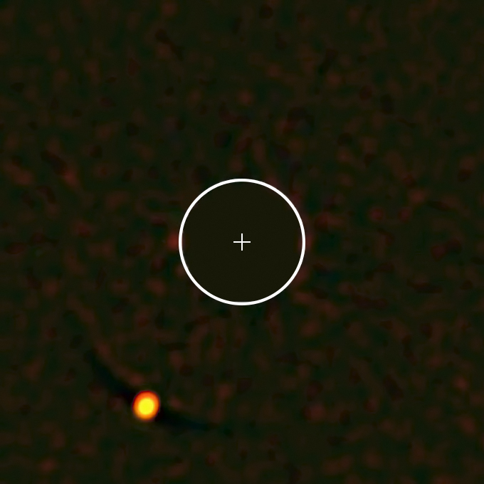 Figure 4: Actual image of the exoplanet HIP 65426b, produced by ESO’s Very Large Telescope. The planet’s star, shown by a cross, has been masked out. The circle indicates the orbit of Neptune on the same scale.