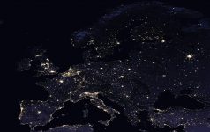 Europe at night as seen from space. Big cities, densely populated areas, and coastlines are brightly illuminated.
